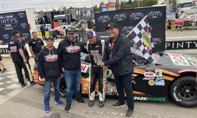 DJ Kennington collecting the winner’s trophy at Delaware Speedway