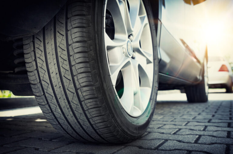 Car tire close up, parked car low angle shot