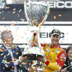 AVONDALE, ARIZONA - NOVEMBER 06: NASCAR President Steve Phelps presents the Bill France NASCAR Cup Series Championship trophy to Joey Logano, driver of the #22 Shell Pennzoil Ford, in victory lane after winning the 2022 NASCAR Cup Series Championship at Phoenix Raceway on November 06, 2022 in Avondale, Arizona. (Photo by Sean Gardner/Getty Images)